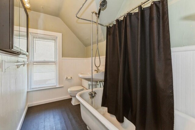 817 Harrison Ave, Saint Joseph, MI 49085 - bathroom with lofted ceiling, hardwood / wood-style flooring, wainscoting, toilet, and a sink