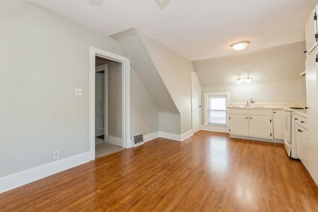 817 Harrison Ave, Saint Joseph, MI 49085 - bonus room with a sink, light wood-type flooring, and baseboards
