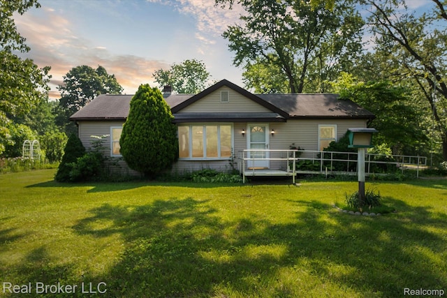 5740 M 66, East Leroy, MI 49051 - back of property at dusk with a yard and a chimney