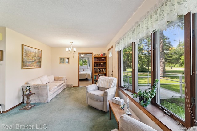 5740 M 66, East Leroy, MI 49051 - living area featuring carpet floors, a chandelier, and a textured ceiling