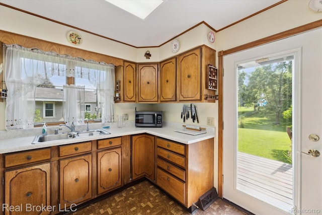 5740 M 66, East Leroy, MI 49051 - kitchen featuring stainless steel microwave, brown cabinets, light countertops, and crown molding