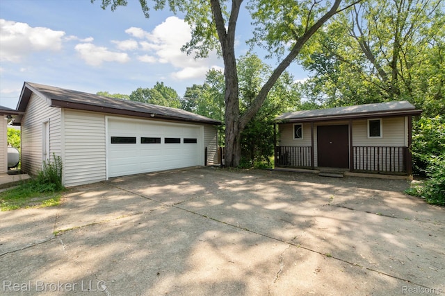 5740 M 66, East Leroy, MI 49051 - view of front of home with a garage, an outbuilding, and covered porch