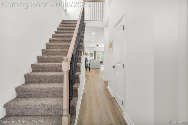 11801 Hines Place Dr, Livonia, MI 48150 - staircase with wood finished floors, a ceiling fan, and baseboards