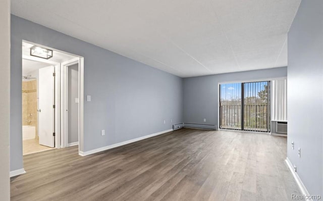 35300 Woodward Ave Unit 408, Birmingham, MI 48009 - unfurnished room with baseboard heating, wood finished floors, and baseboards