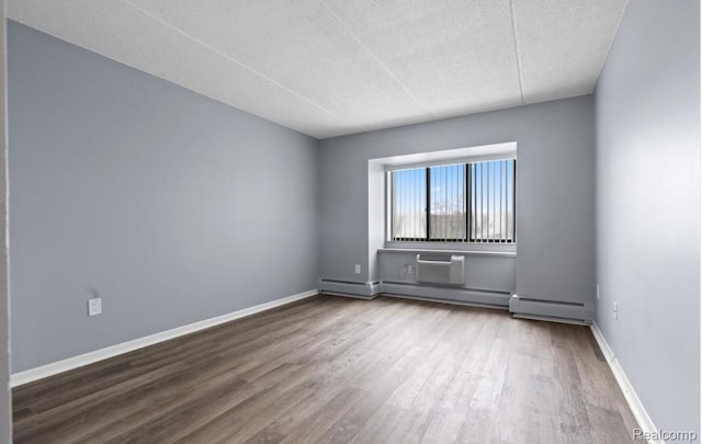 35300 Woodward Ave Unit 408, Birmingham, MI 48009 - empty room with wood finished floors, a textured ceiling, and baseboards