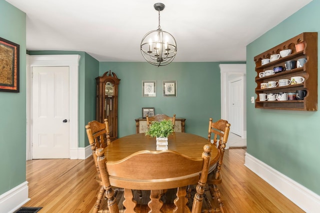 46860 Shelby Rd, Michigan, MI 48317 - dining area with a chandelier, light wood-type flooring, and baseboards