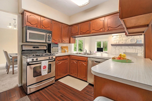 4014 Orchard Crest Dr, West Bloomfield, MI 48322 - kitchen featuring appliances with stainless steel finishes, a sink, light countertops, and brown cabinets