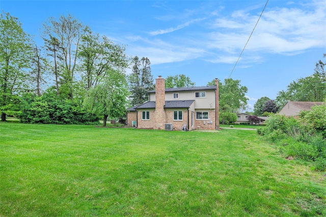 4014 Orchard Crest Dr, West Bloomfield, MI 48322 - rear view of house featuring a chimney, a yard, cooling unit, and brick siding