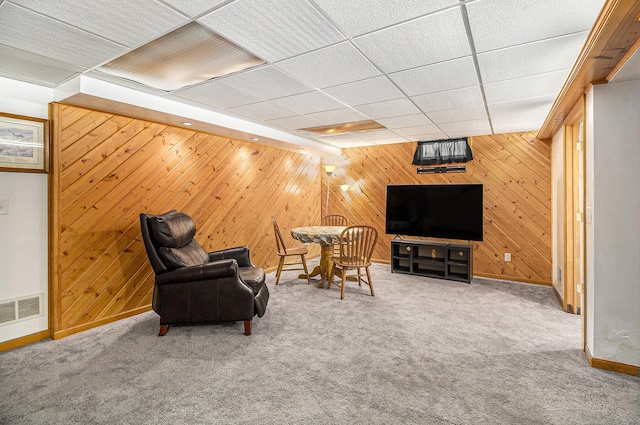 130 Woodway Ave, Battle Creek, MI 49014 - living area featuring baseboards, wooden walls, carpet flooring, and a paneled ceiling