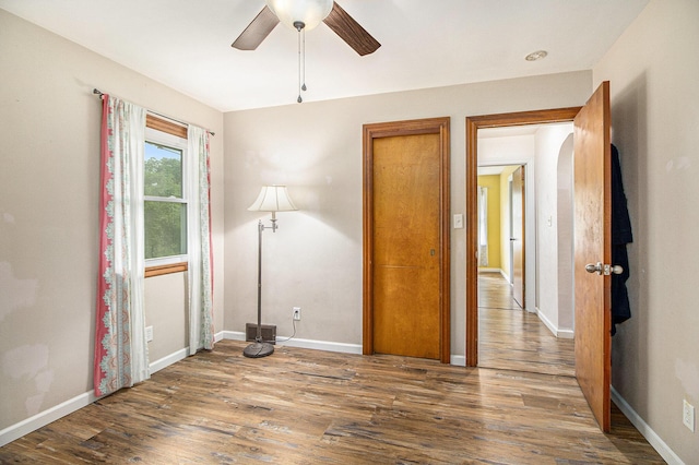 130 Woodway Ave, Battle Creek, MI 49014 - empty room with a ceiling fan, wood finished floors, and baseboards
