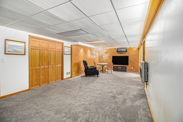 130 Woodway Ave, Battle Creek, MI 49014 - living area featuring wood walls, carpet floors, and baseboards