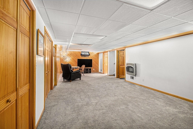 130 Woodway Ave, Battle Creek, MI 49014 - unfurnished room with wood walls, light carpet, heating unit, baseboards, and a paneled ceiling