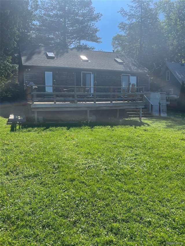 1749 Tannock Dr, Holly, MI 48442 - back of property featuring a yard and a deck