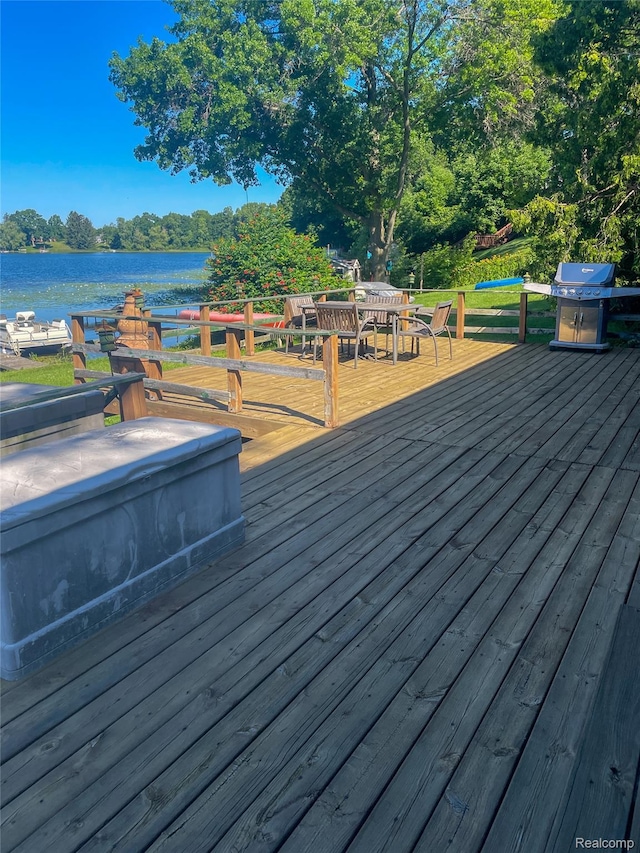 1749 Tannock Dr, Holly, MI 48442 - wooden deck featuring a grill, outdoor dining space, and a water view