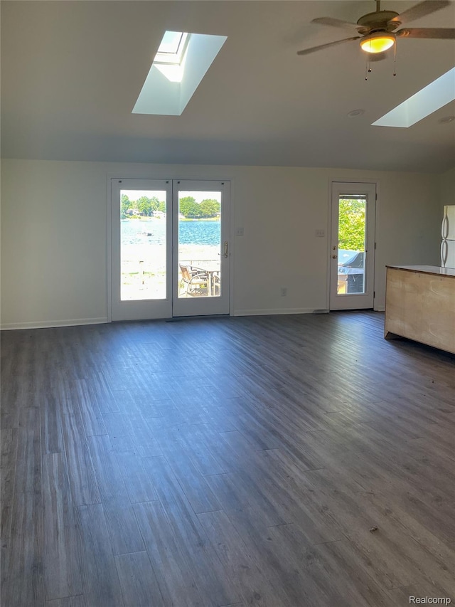1749 Tannock Dr, Holly, MI 48442 - unfurnished living room with a skylight, ceiling fan, lofted ceiling, and wood finished floors
