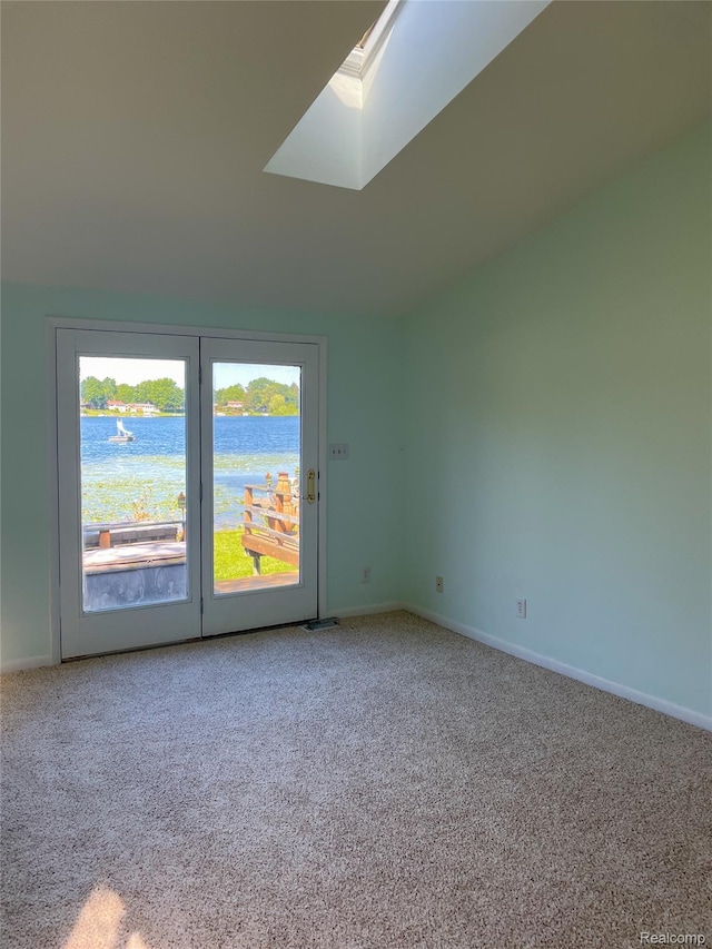 1749 Tannock Dr, Holly, MI 48442 - carpeted empty room featuring a skylight and a water view