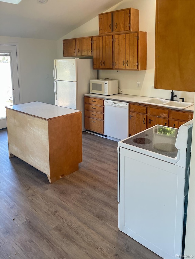 1749 Tannock Dr, Holly, MI 48442 - kitchen with white appliances, brown cabinetry, vaulted ceiling, dark wood-type flooring, and a center island