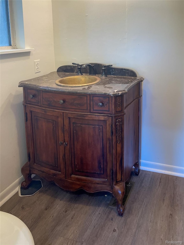 1749 Tannock Dr, Holly, MI 48442 - bathroom featuring wood finished floors and vanity