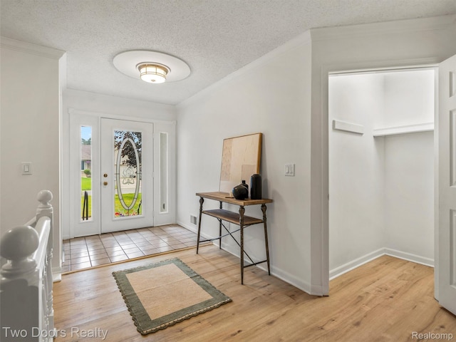 53020 Wolf Dr, Shelby Twp, MI 48316 - entrance foyer featuring ornamental molding, a textured ceiling, wood finished floors, and baseboards