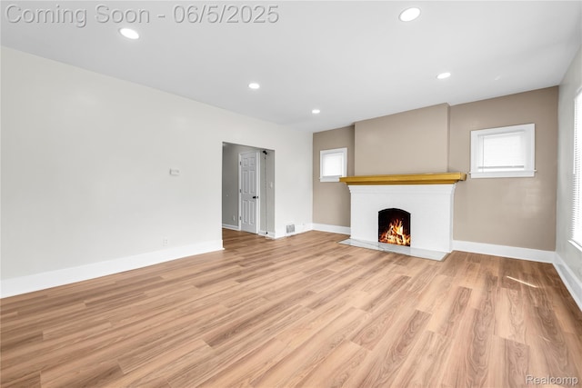14953 Winthrop St, Detroit, MI 48227 - unfurnished living room with a brick fireplace, recessed lighting, baseboards, and light wood finished floors