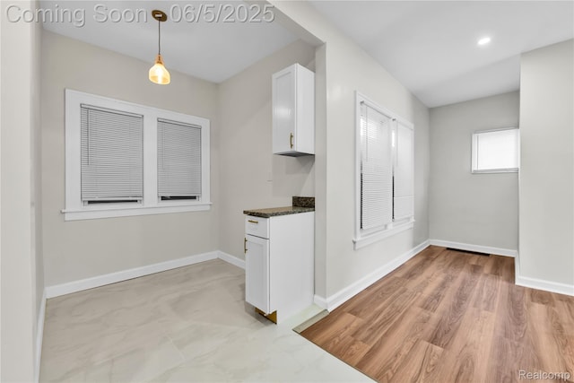 14953 Winthrop St, Detroit, MI 48227 - kitchen with white cabinetry, baseboards, pendant lighting, and dark stone countertops