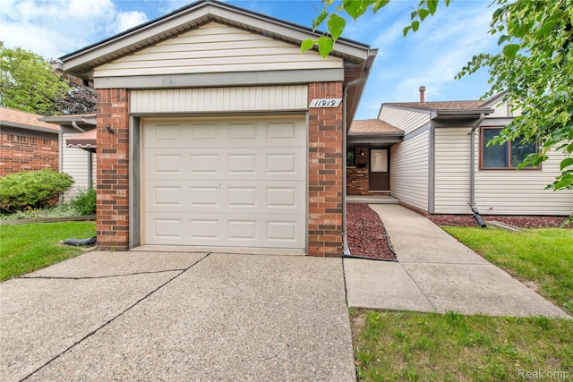 11919 Ina Dr, Sterling Heights, MI 48312 - single story home featuring driveway, brick siding, and a garage