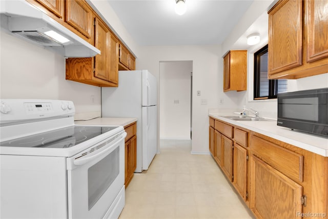 11919 Ina Dr, Sterling Heights, MI 48312 - kitchen featuring white appliances, under cabinet range hood, light countertops, brown cabinetry, and light flooring