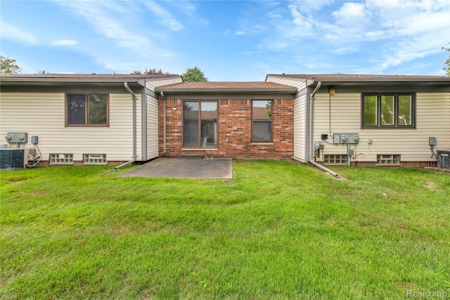 11919 Ina Dr, Sterling Heights, MI 48312 - rear view of property featuring a patio, a lawn, and brick siding