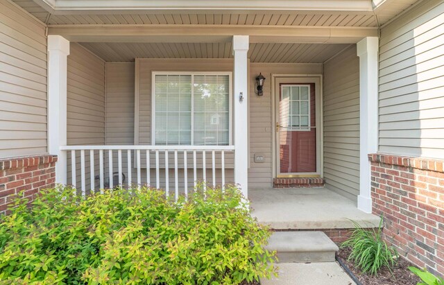 392 Woodfield Square Ln, Brighton, MI 48116 - doorway to property with a porch and brick siding