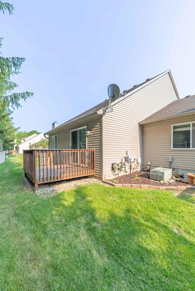 392 Woodfield Square Ln, Brighton, MI 48116 - back of property featuring a lawn, a deck, and central AC unit