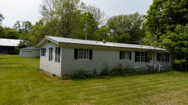 5125 S 148th Ave, Hesperia, MI 49421 - view of front of home featuring a detached garage, a front yard, and a metal roof