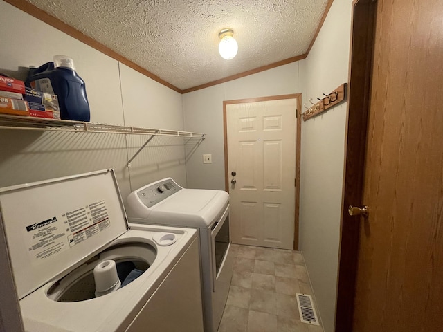 8295 Mccain Rd, Parma, MI 49269 - laundry room with washing machine and dryer, ornamental molding, and a textured ceiling