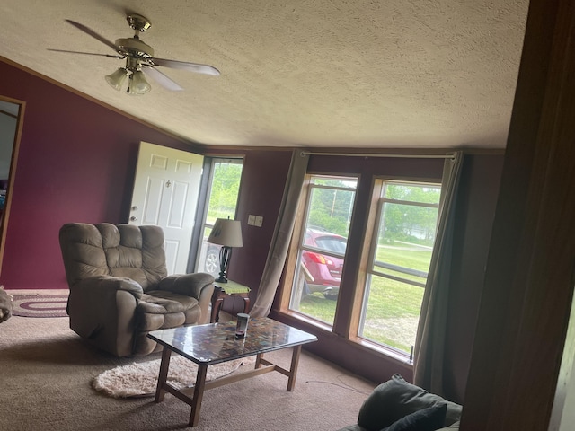 8295 Mccain Rd, Parma, MI 49269 - carpeted living room with a textured ceiling, a ceiling fan, lofted ceiling, and plenty of natural light
