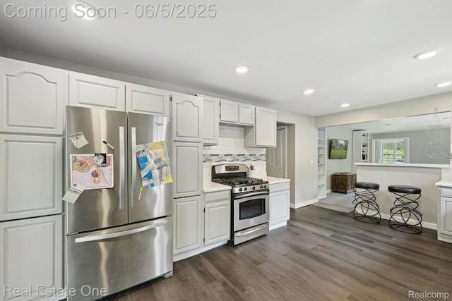 8921 Lake Rd, Grosse Ile, MI 48138 - kitchen with appliances with stainless steel finishes, light countertops, dark wood-style flooring, and recessed lighting
