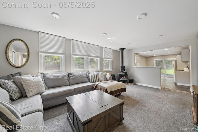 8921 Lake Rd, Grosse Ile, MI 48138 - carpeted living room with a wood stove, recessed lighting, and baseboards