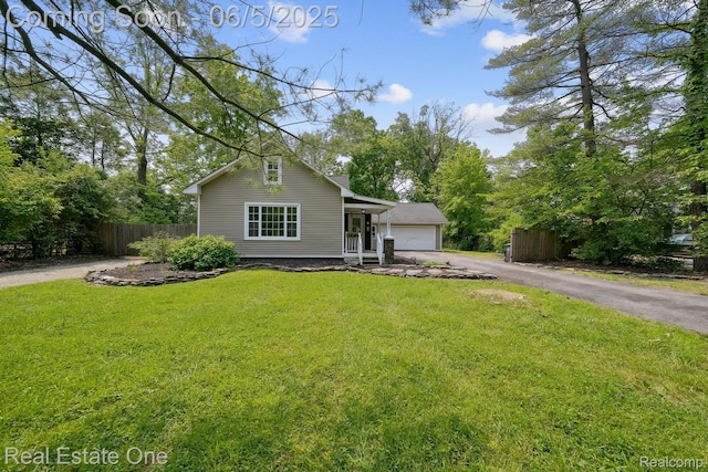 8921 Lake Rd, Grosse Ile, MI 48138 - view of front facade with a garage and asphalt driveway