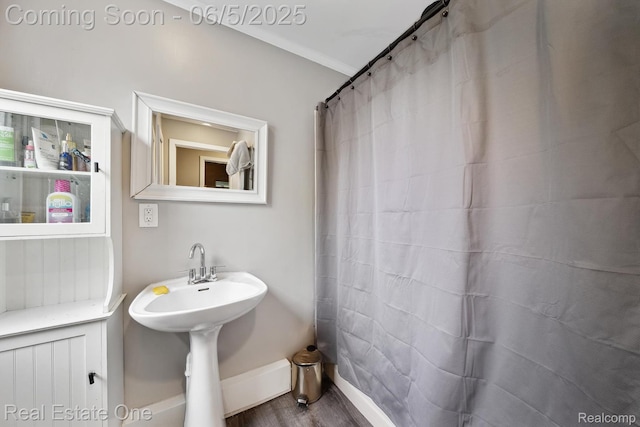 8921 Lake Rd, Grosse Ile, MI 48138 - full bath featuring wood finished floors, baseboards, and a shower with curtain