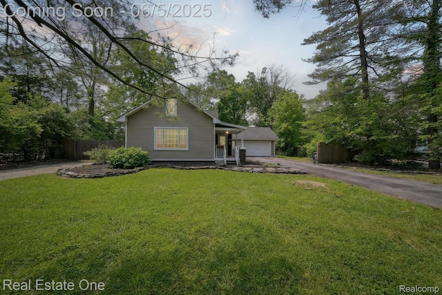 8921 Lake Rd, Grosse Ile, MI 48138 - view of front facade with a garage and asphalt driveway