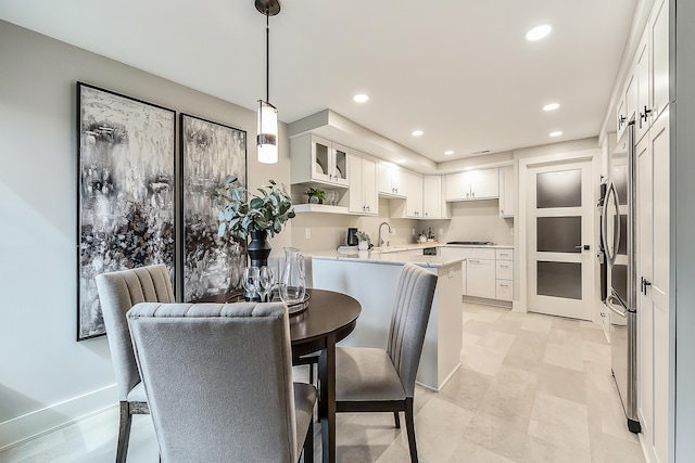3000 Glazier Way Unit 130, Ann Arbor, MI 48105 - kitchen featuring a peninsula, a sink, white cabinets, recessed lighting, and gas stovetop