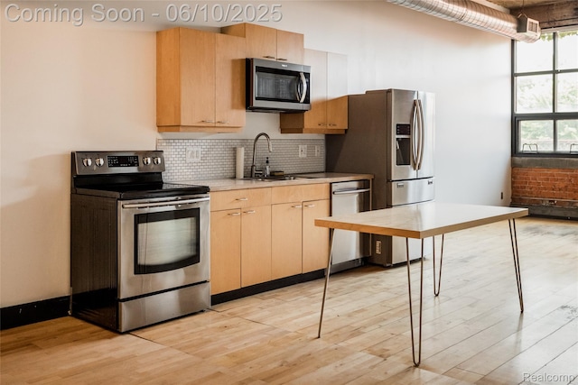 460 W Canfield Street Loft 207/ Unit 16, Detroit, MI 48201 - kitchen with stainless steel appliances, light countertops, decorative backsplash, light wood-type flooring, and light brown cabinets