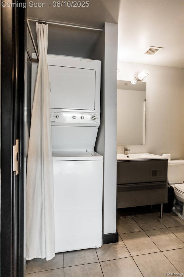 460 W Canfield Street Loft 207/ Unit 16, Detroit, MI 48201 - washroom with stacked washer / drying machine and light tile patterned floors