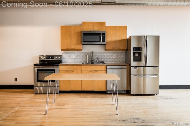 460 W Canfield Street Loft 207/ Unit 16, Detroit, MI 48201 - kitchen featuring stainless steel appliances, a sink, baseboards, and light wood-style flooring