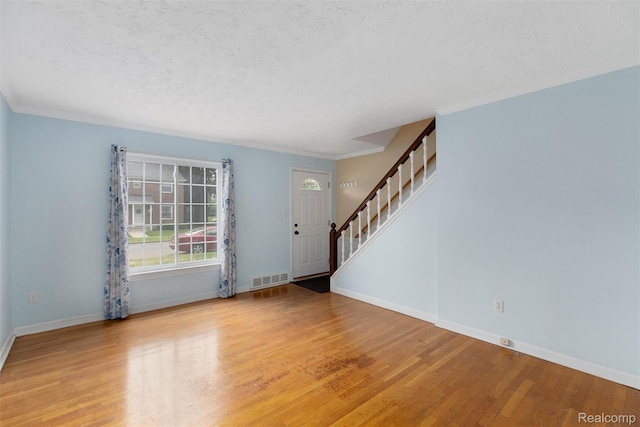 22953 Allen Rd, Saint Clair Shores, MI 48080 - foyer with stairs, wood finished floors, ornamental molding, and a textured ceiling