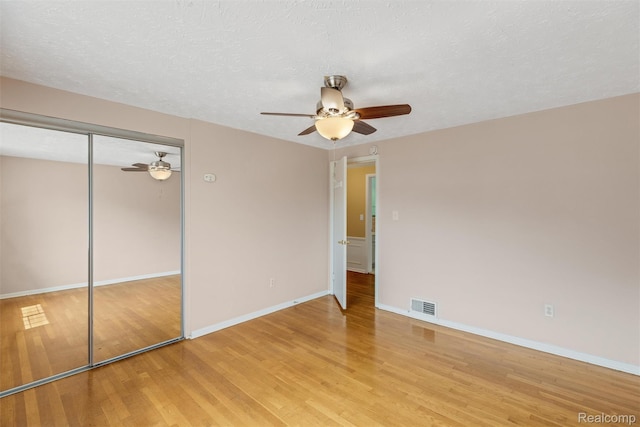 22953 Allen Rd, Saint Clair Shores, MI 48080 - unfurnished bedroom with light wood-style floors, a closet, a ceiling fan, and a textured ceiling