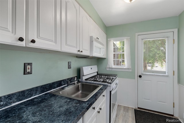 22953 Allen Rd, Saint Clair Shores, MI 48080 - kitchen with white appliances, dark countertops, white cabinetry, and light wood finished floors
