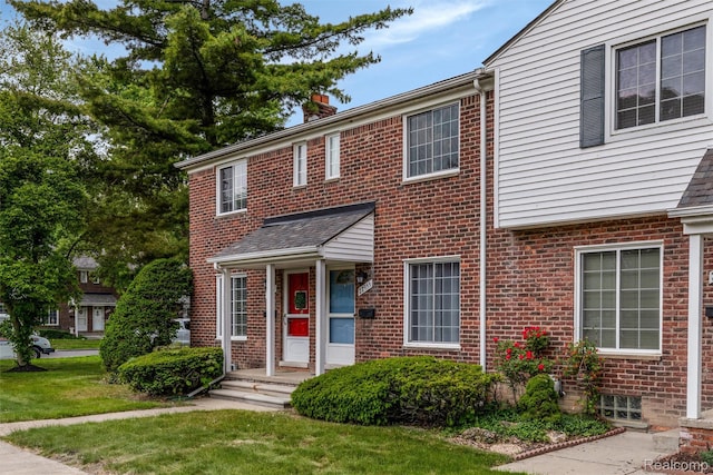 22953 Allen Rd, Saint Clair Shores, MI 48080 - townhome / multi-family property with a chimney, brick siding, and a front yard