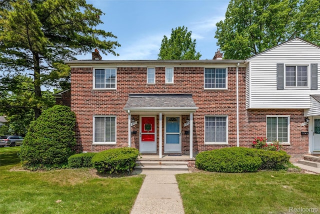 22953 Allen Rd, Saint Clair Shores, MI 48080 - view of front of property featuring a chimney, a front yard, and brick siding