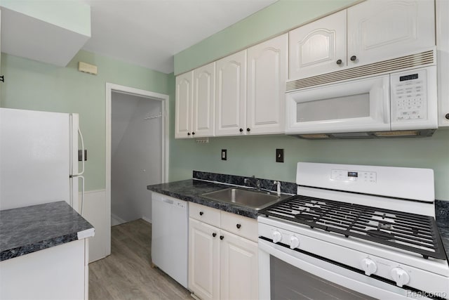 22953 Allen Rd, Saint Clair Shores, MI 48080 - kitchen featuring white appliances, dark countertops, light wood-style floors, and white cabinetry