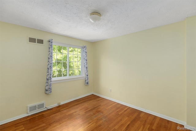 22953 Allen Rd, Saint Clair Shores, MI 48080 - unfurnished room featuring light wood-style flooring and a textured ceiling