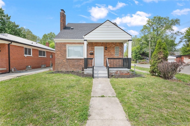 19215 Winthrop St, Dearborn, MI 48235 - bungalow-style house with a chimney, brick siding, a front yard, and covered porch